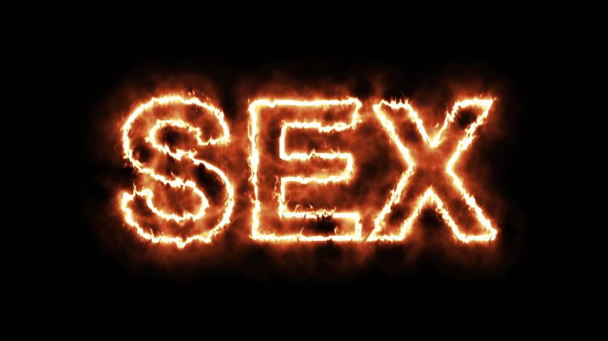 word SEX burning on fire on black background