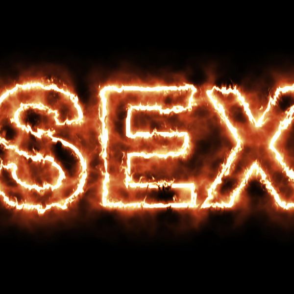 word SEX burning on fire on black background