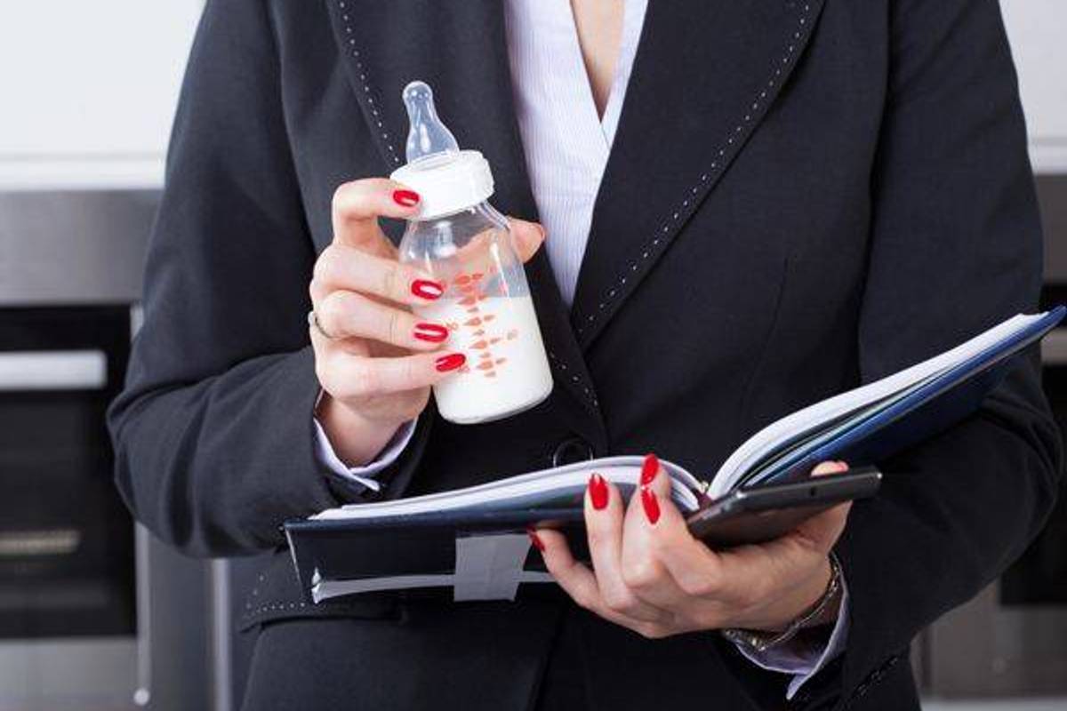 working mother holding a baby bottle