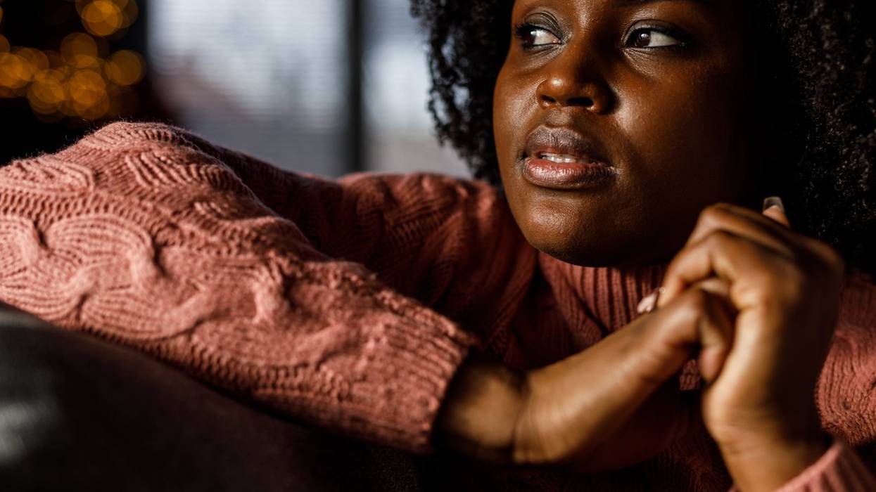 worried young woman lounging on the sofa