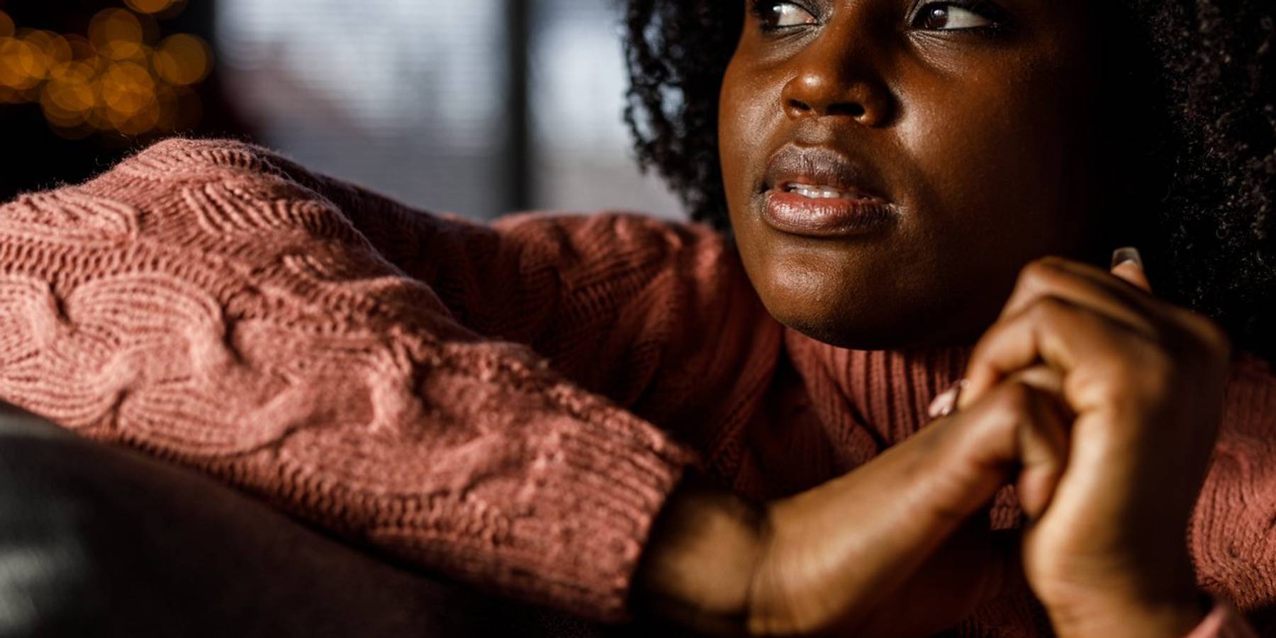 worried young woman lounging on the sofa