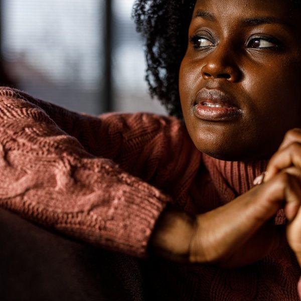 worried young woman lounging on the sofa
