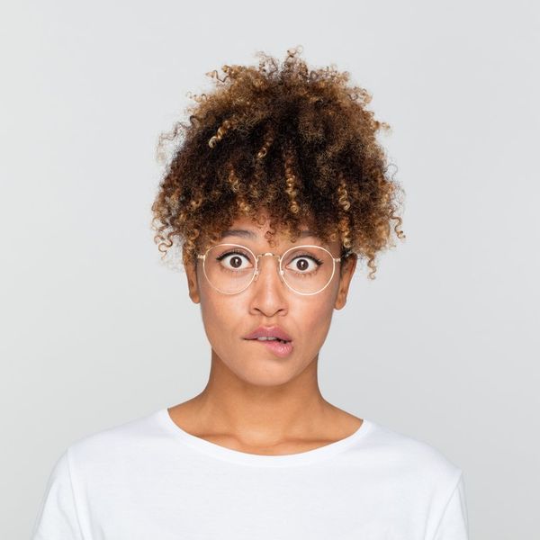 young afro american woman looking nervous, biting her lips