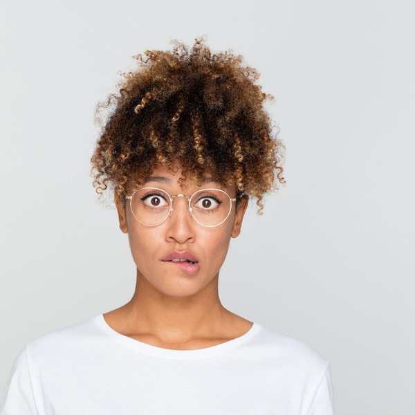 young afro american woman looking nervous, biting her lips