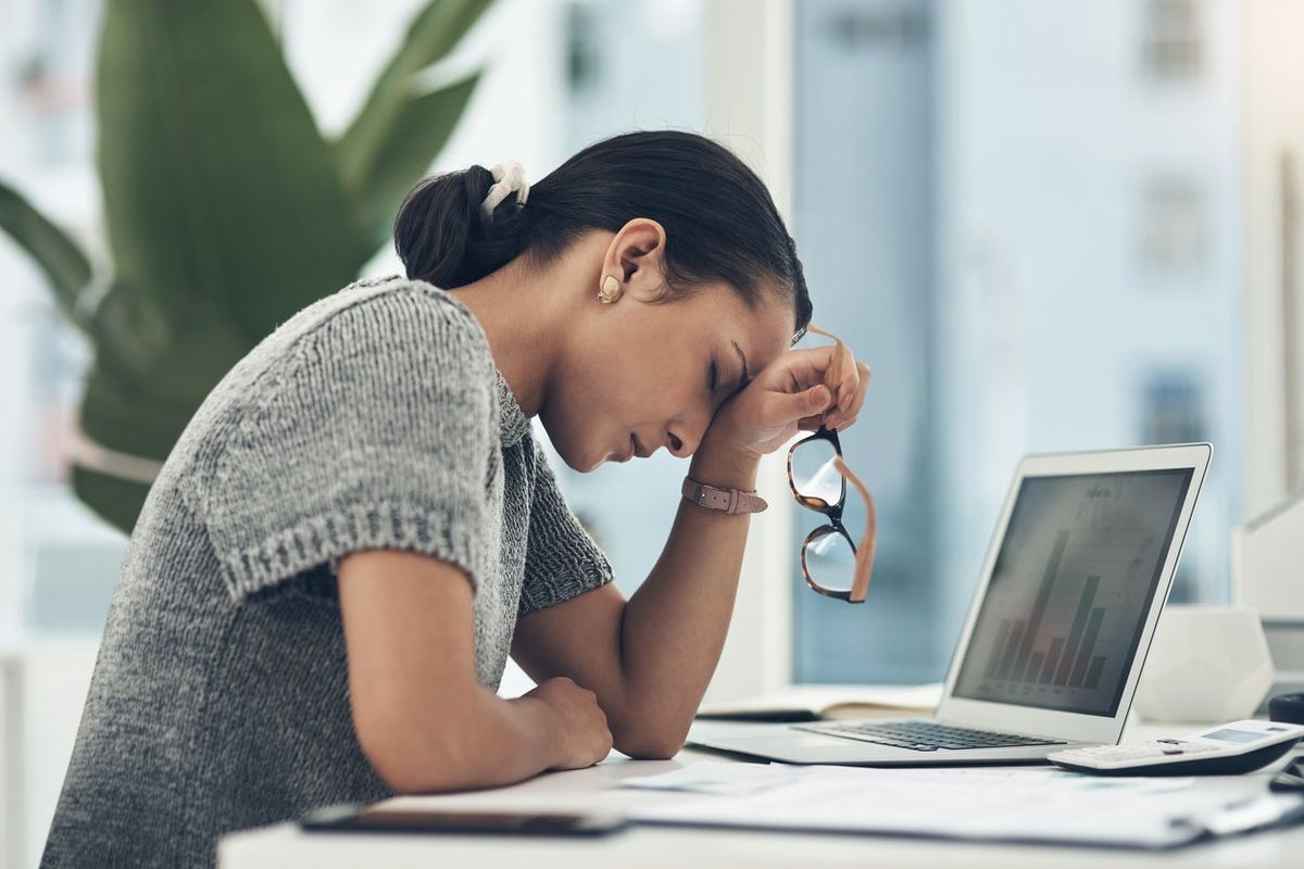 young businesswoman looking tired while working in an office