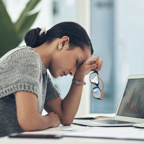 young businesswoman looking tired while working in an office