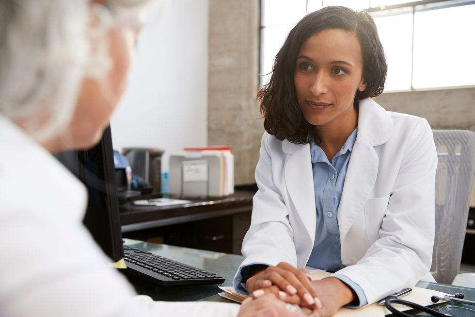 Young female doctor in consultation with senior patient about opioid abuse