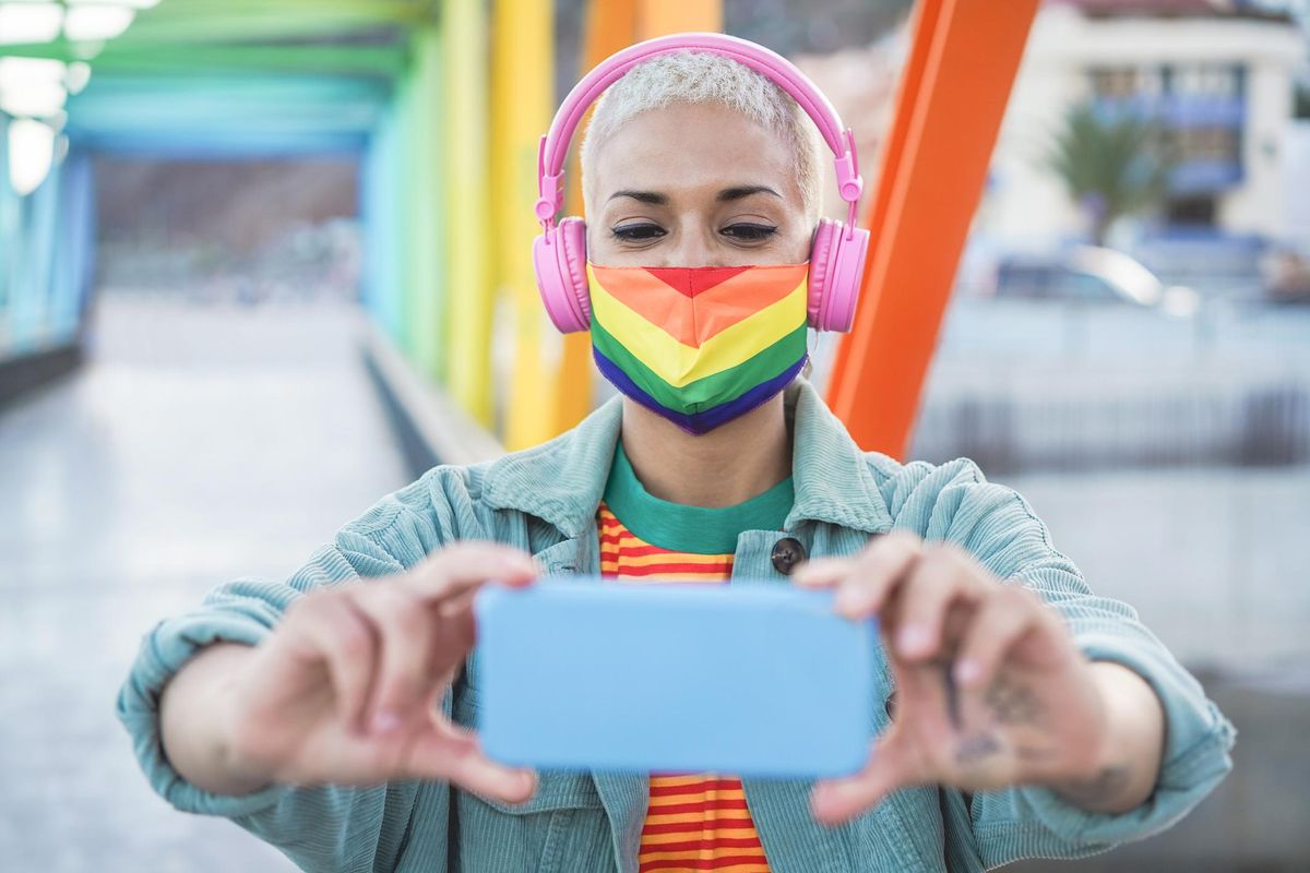 Young gay woman taking selfie