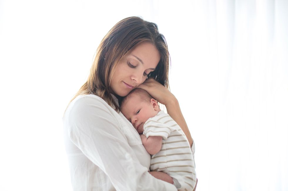 Young mother, holding her newborn baby