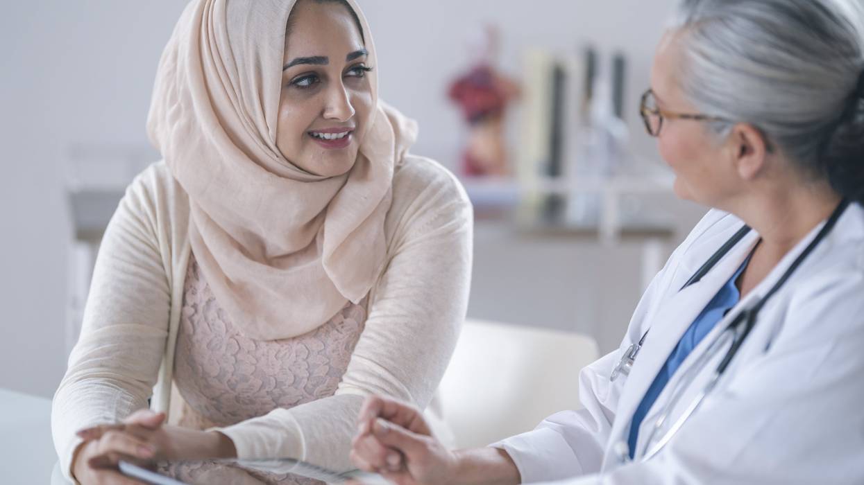 young Muslim woman is meeting with her doctor.