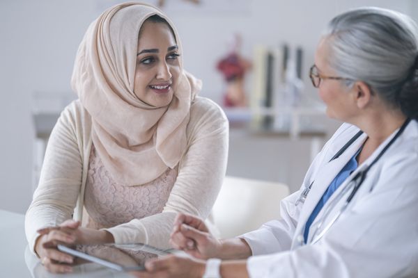 young Muslim woman is meeting with her doctor.