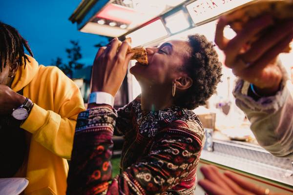 Young Woman Eating Pizza