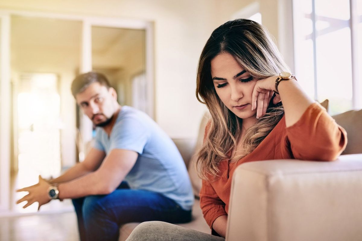 young woman looking upset after a fight with her partner at home