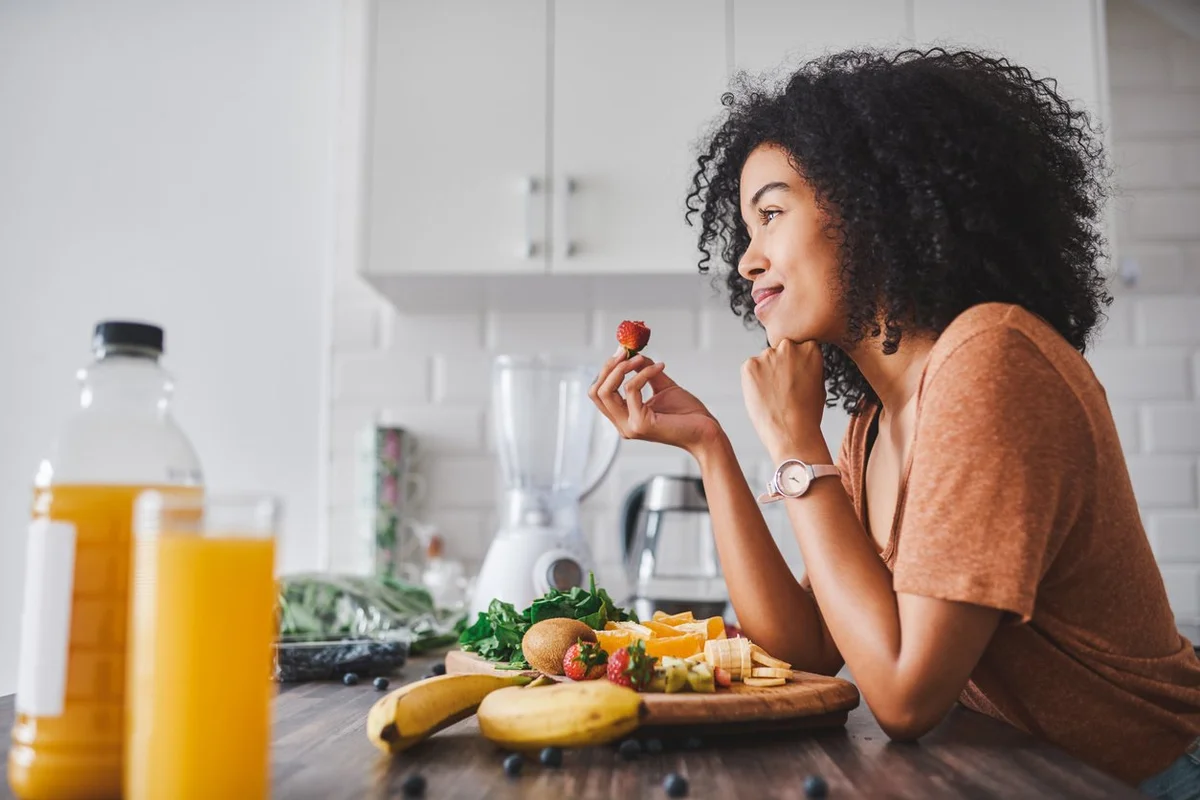 young woman making a healthy snack with fruit at home