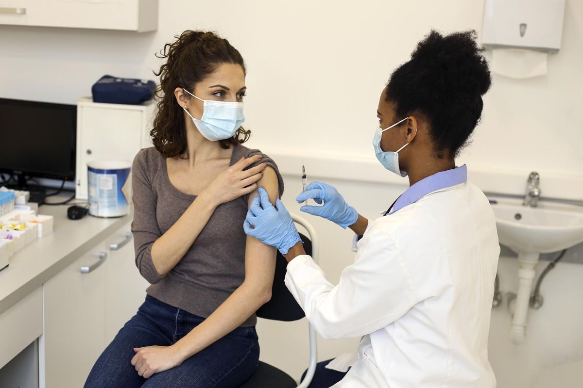 Young woman receiving a COVID-19 vaccine