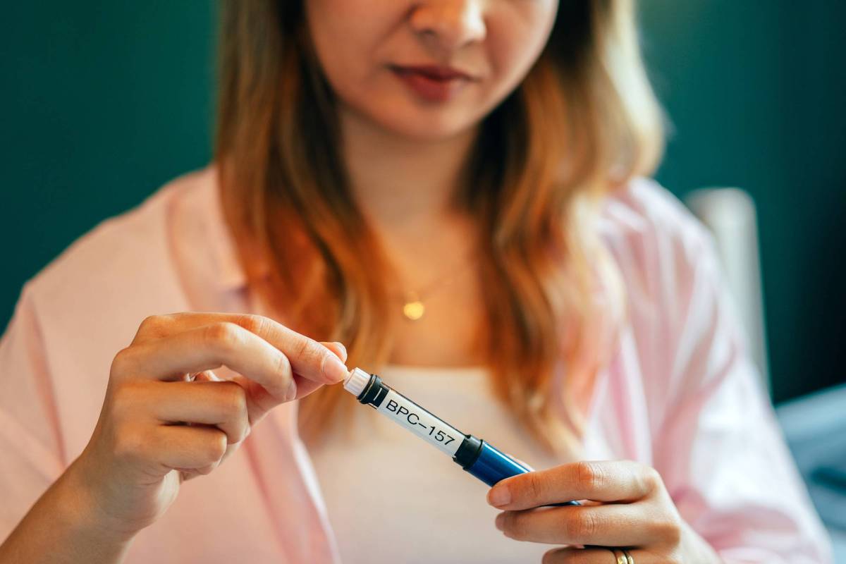 Young Woman Using BPC-157 Peptide Injection at Home