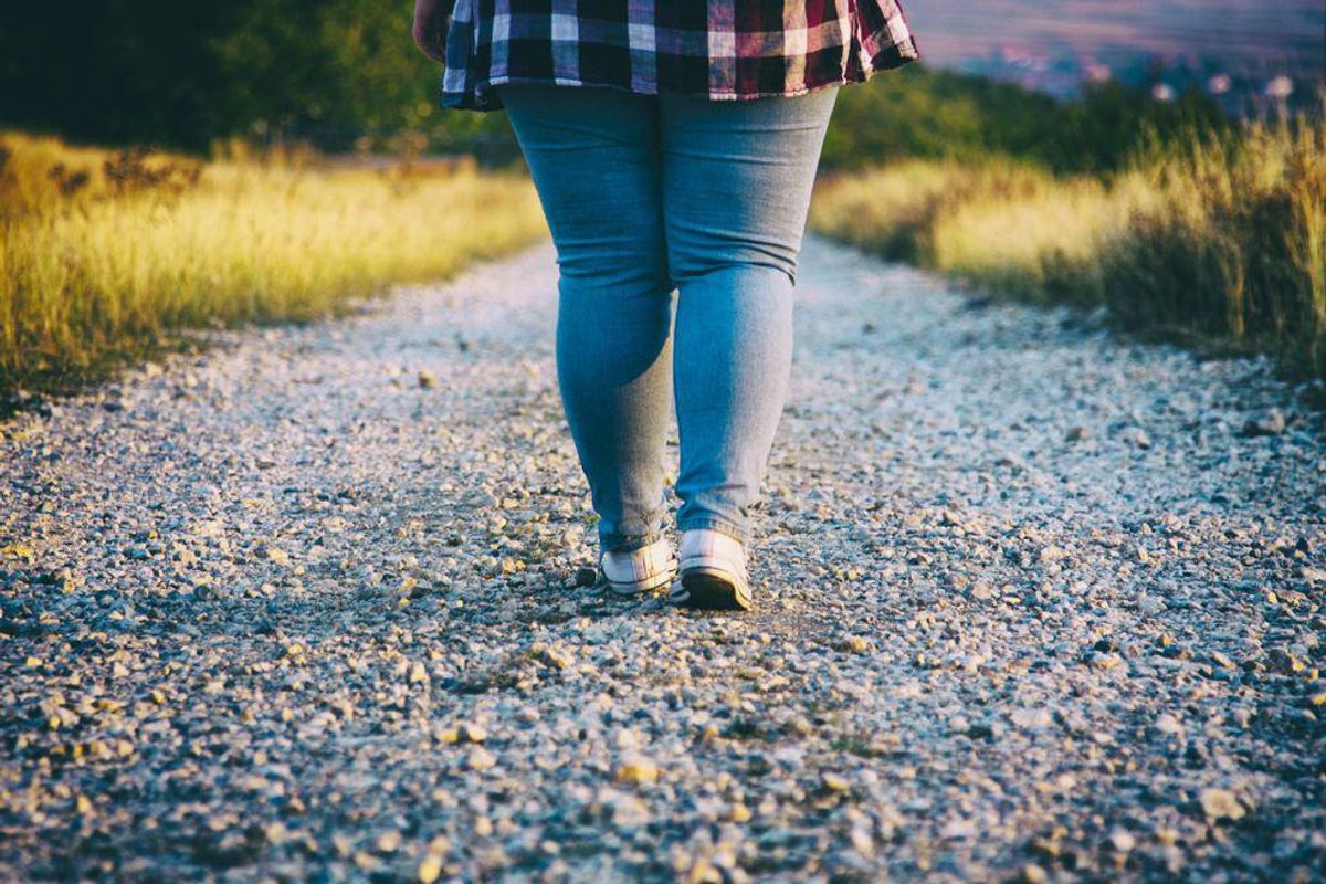 Young woman walking on country road