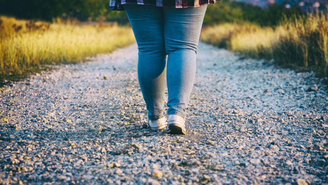 Young woman walking on country road